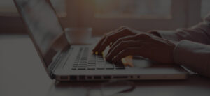 Hands typing on a computer